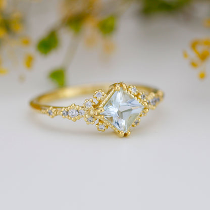 Vintage-Ring mit 5x5 mm großem Aquamarin im Prinzessschliff und Diamantcluster, 18 Karat