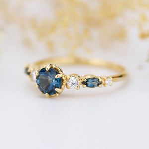 Cluster engagement ring round London blue topaz with marquise stone on the side - NOOI JEWELRY